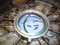  It appears that a flat circular disk of rubber which sat in the middle of the seal unit between the casing and the lip part, had disintegrated and come out, allowing oil to pass behind the lip - I should have used Genuine Parts!